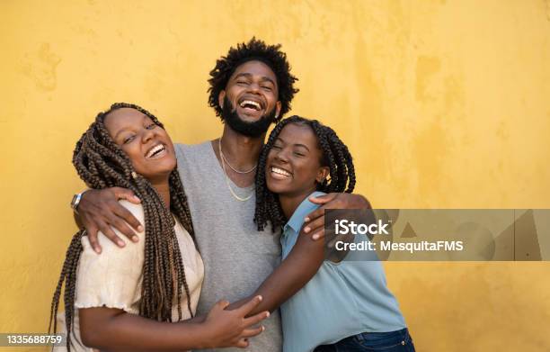 Hugging Afro People Yellow Background Stock Photo - Download Image Now - African Ethnicity, Friendship, Teenager