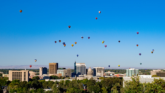 Colorful hot air balloons flying in the blue sky with white clouds