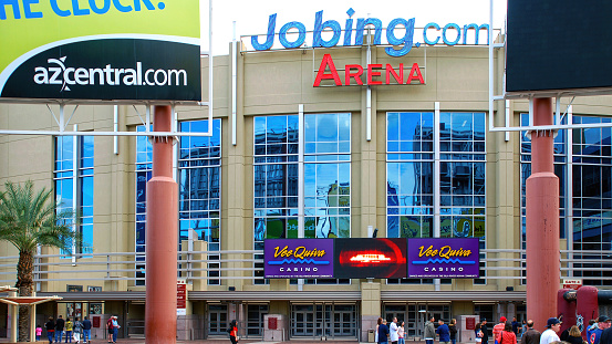 Glendale, AZ, USA - February 7, 2009: People walk outside Jobing.com arena (now Gila River Arena) where the NHL Phoenix Coyotes (now Arizona Coyotes) team plays. Naming rights to the arena belonged to Jobing.com from 2006-2014 until a new deal was struck with  Gila River Casinos.