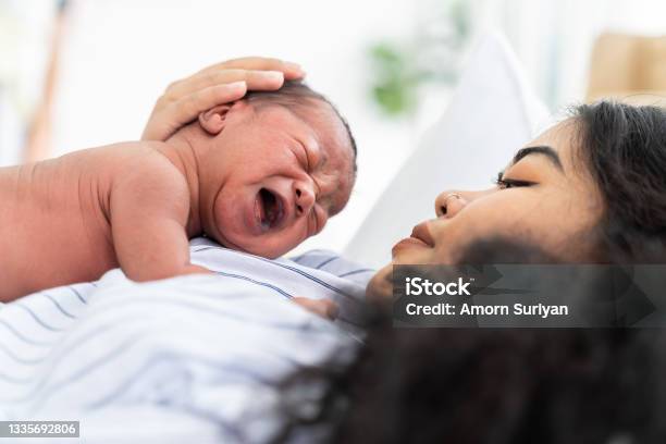 Newborn Baby Crying On Mothers Mother Take Care Her African American Infant On Hands With Kindness Family Love Happy And New Life Concept Stock Photo - Download Image Now