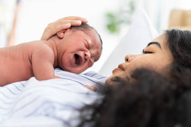 newborn baby crying on mother's. mother take care her african american infant on hands with kindness. family, love, happy and new life concept - family american culture african culture black imagens e fotografias de stock