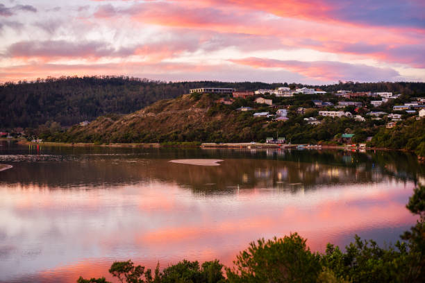istock Homes sitting on a hill by an inlet reflecting the sunset 1335695167