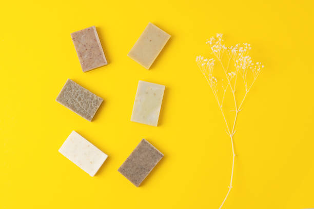 istock Soap with flowers on yellow background. Flat lay, copy space. 1335695199