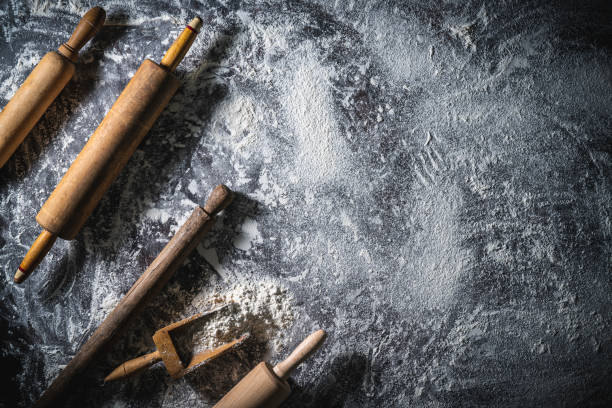 istock Rolling pin and flour serving scoop on flour spread background abstract for bakery themes 1335696186