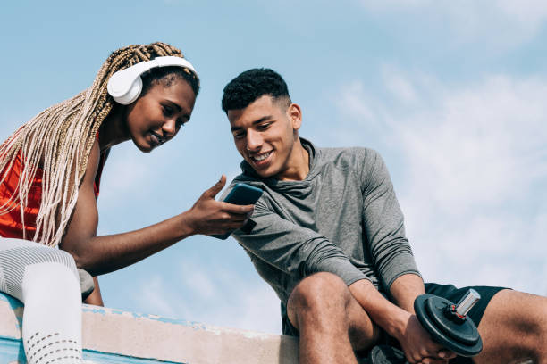istock Multiracial sport people watching video on mobile phone after workout session outdoors in the city - Focus on man face 1335696552
