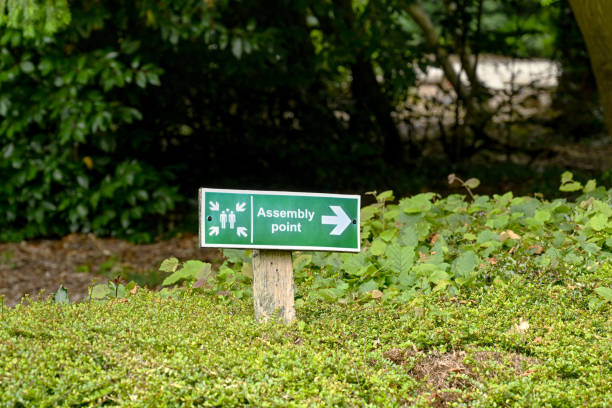 istock Sign outside a building pointing to a fire assembly point 1335697107