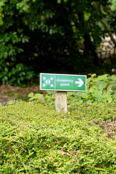 istock Sign outside a building pointing to a fire assembly point 1335697114