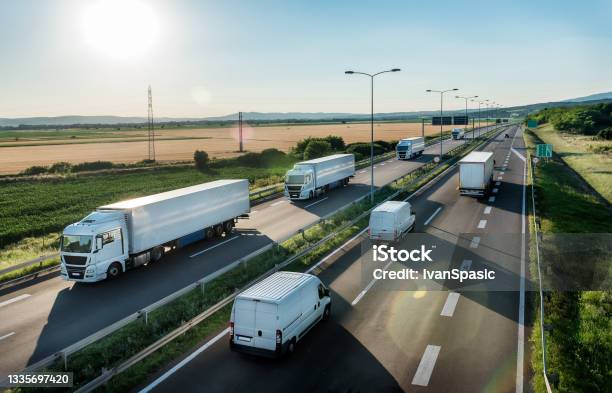 Highway Transit Photo With Convoy Of Transportation Trucks Stock Photo - Download Image Now