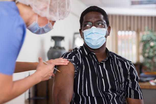 istock African american office employee getting antiviral injection at workplace 1335697579
