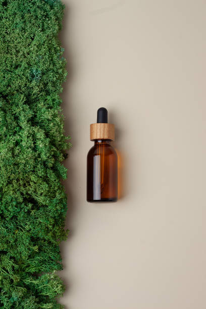 istock Cosmetic bottle with moss natural backgroundon pastel beige. Flat lay 1335698653
