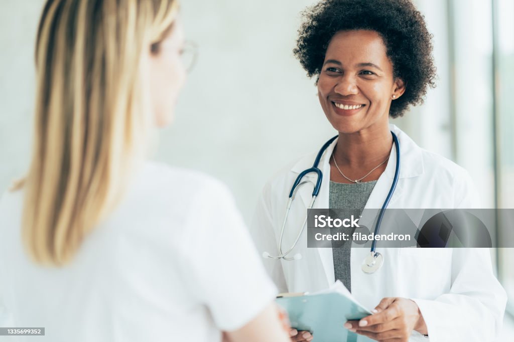 Two Doctors Conversation Two Doctors Talking At Hospital Stock Photo - Download Image Now ...