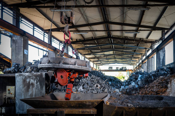 istock Moving scrap steel using magnetic device on crane in warehouse hall 1335706407