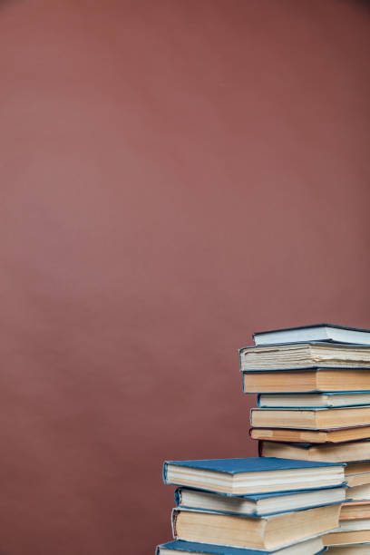 istock Stacks of books for teaching knowledge university library brown background 1335707618