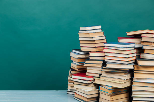 istock Stacks of books for teaching knowledge college library green background 1335707632