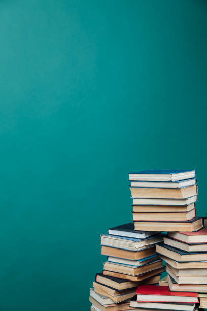 istock Stacks of books for teaching knowledge college library green background 1335708654