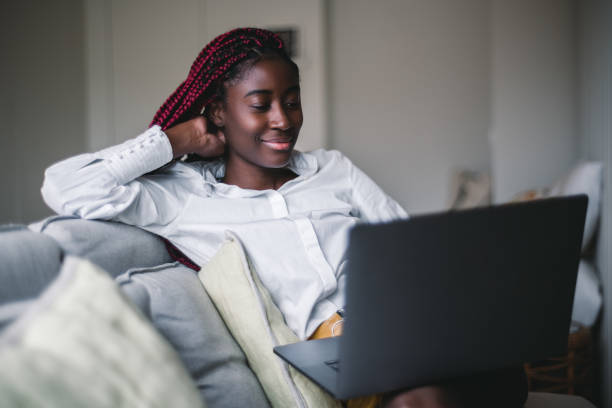 istock Black girl working on laptop at home 1335710152