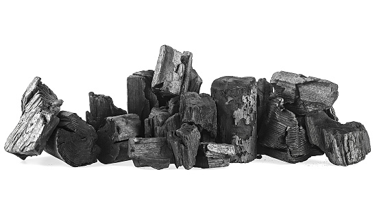 Pile of charcoal isolated on a white background. Natural wood charcoal. Hard wood charcoal.