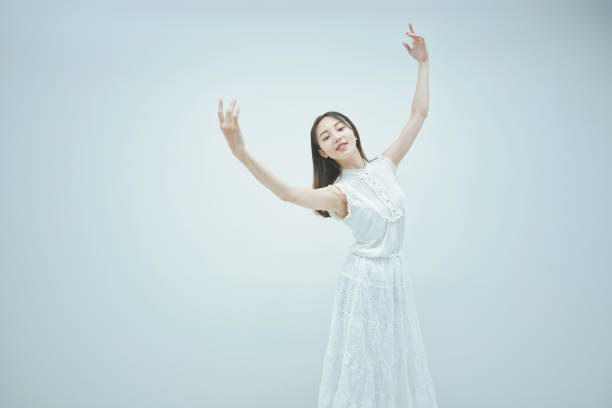 istock Asian young woman dancing gracefully 1335714969