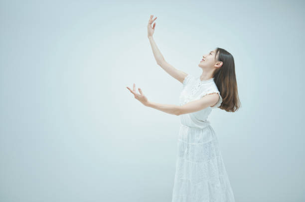 istock Asian young woman dancing gracefully 1335714985
