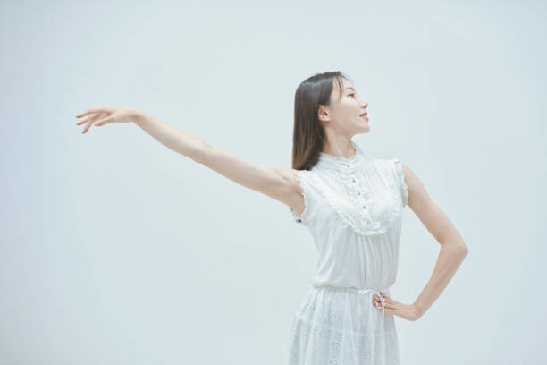 istock Asian young woman dancing gracefully 1335715040