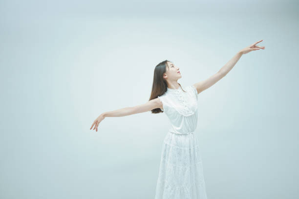 istock Asian young woman dancing gracefully 1335715132