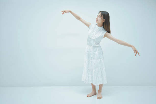 istock Asian young woman dancing gracefully 1335715175