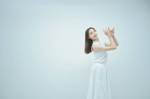 istock Asian young woman dancing gracefully 1335715272