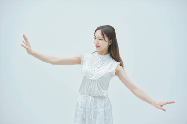 istock Asian young woman dancing gracefully 1335715384