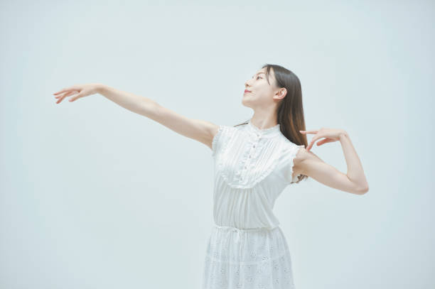 istock Asian young woman dancing gracefully 1335716139