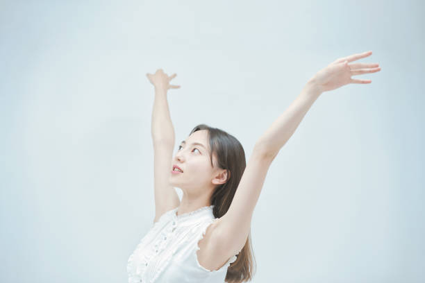 istock Asian young woman dancing gracefully 1335716160