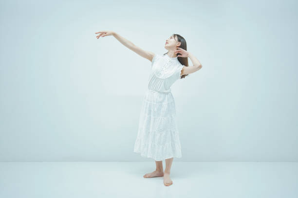 istock Asian young woman dancing gracefully 1335716259