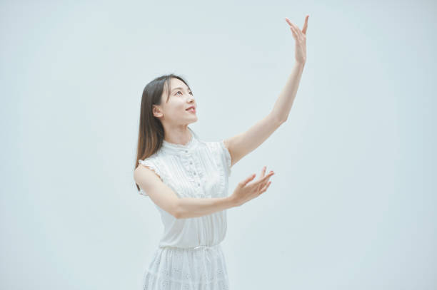 istock Asian young woman dancing gracefully 1335716349
