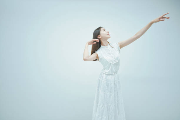 istock Asian young woman dancing gracefully 1335716371