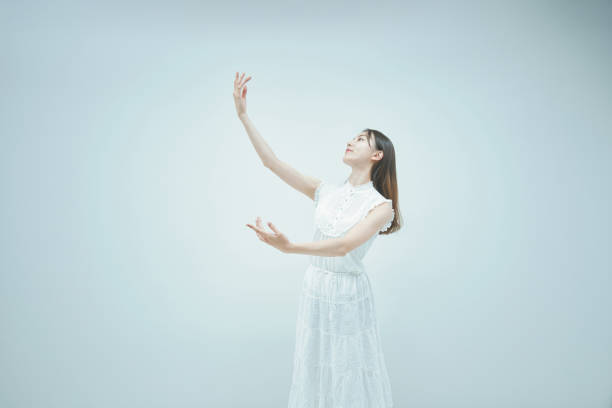 istock Asian young woman dancing gracefully 1335716390