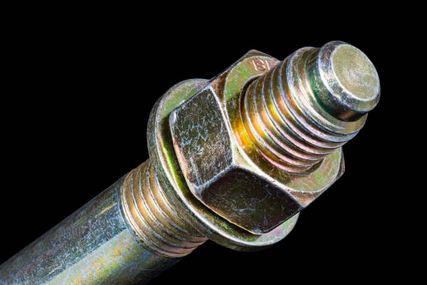 istock Hexagonal nut and washer on metal galvanized wedge expansion anchor bolt end on a black background 1335717719