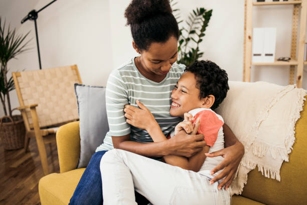 istock Boy tickling and playing with his mom 1335717933