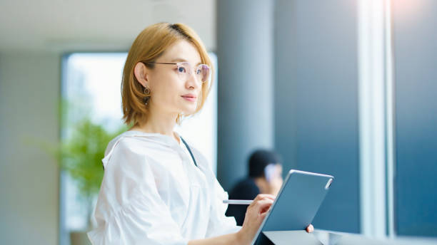 istock A woman operating a tablet PC in the city 1335720888