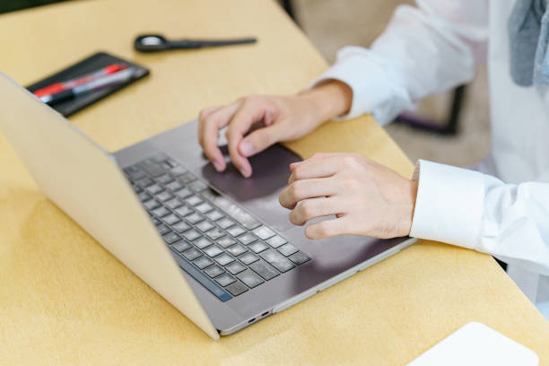 istock Young man using a laptop in a casual space 1335721814