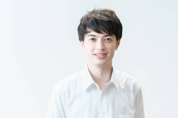 istock A young man wearing a white shirt and smiling 1335722306