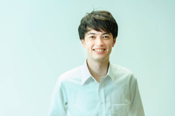 istock A young man wearing a white shirt and smiling 1335722321