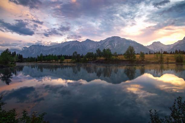 istock Summer Sunrise Reflecting On Quarry Lake In Canmore 1335729409