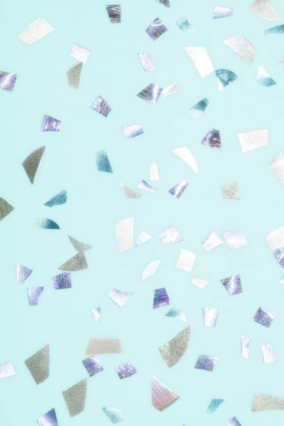 istock shiny metallic confetti on a pastel blue background 1335730558