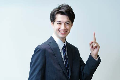 Asian businessman posing with his index finger up
