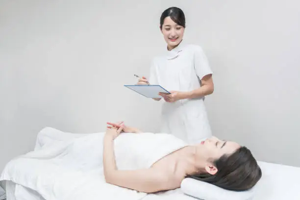 Asian female staff at an esthetic salon providing counseling