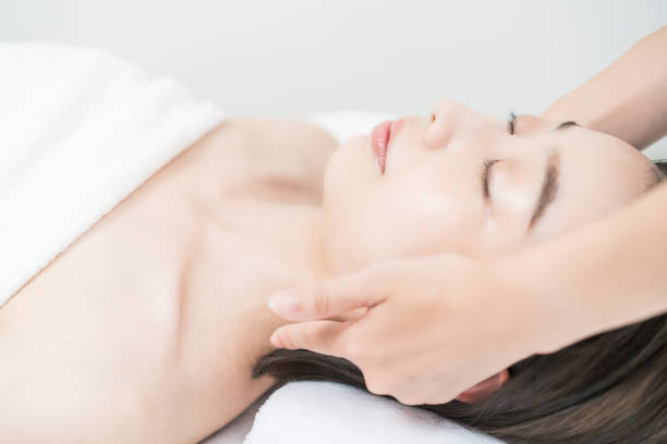 istock A young woman whose head is massaged at an esthetic salon 1335734472