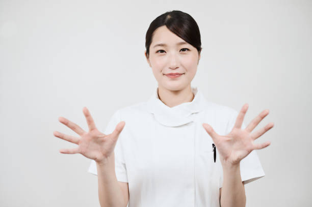 istock A woman in a white coat posing with her hands open 1335739372