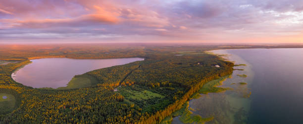Autumn sunrise over beautiful lakes. Autumn panorama with lakes. Aerial view at fall landscape under pink vivid sky. Autumn sunrise over beautiful landscape with lakes and green forest. Scenic nature background. braslav lakes stock pictures, royalty-free photos & images