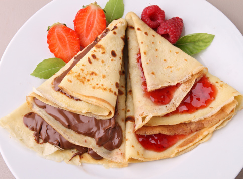 Crepe pancake with fruit and chocolate topping