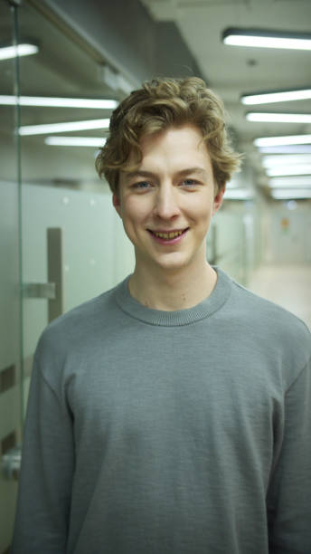 istock A young man is looking to the camera and smiling 1335759449