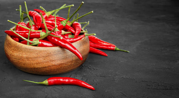 istock chili peppers in a wooden plate 1335760688